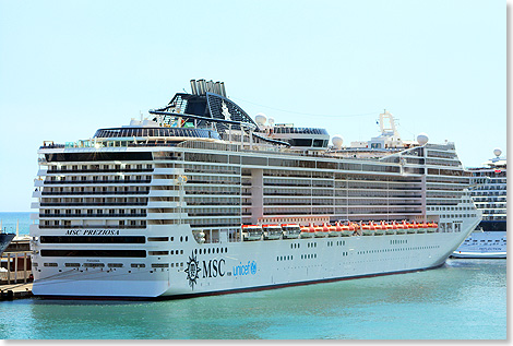 Foto: Kai Ortel, Berlin Die MSC PREZIOSA an einem sommerlichen Aprilnachmittag an der langen, für Kreuzfahrtschiffe vorbestimmten Außenmole von Barcelona