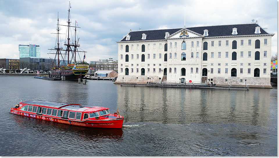 Das Schifffahrtsmuseum von Amsterdam mit historischem Segler BATAVIA und einem Grachtenboot.